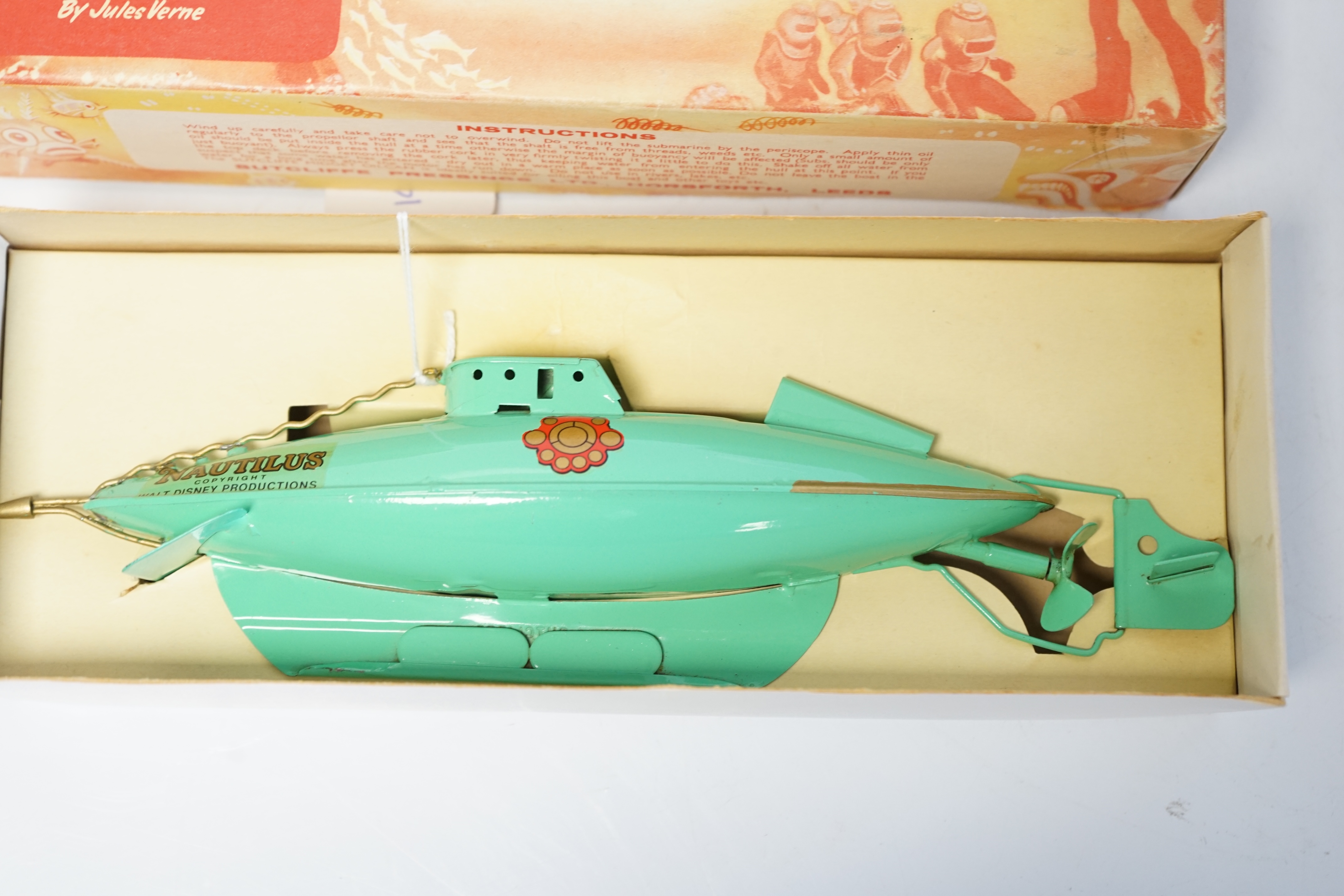 A Sutcliffe Models Nautilus clockwork tinplate submarine modelled on Walt Disney’s 20,000 Leagues Under the Sea, boxed with inner packing card piece. Condition - good, a fine example